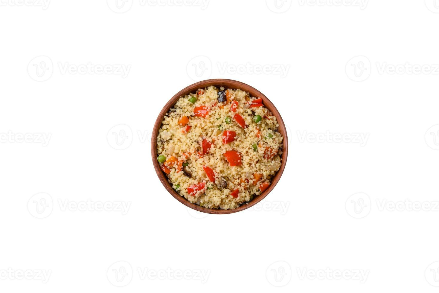 Delicious couscous porridge with cubes of grilled vegetables with salt and spices photo