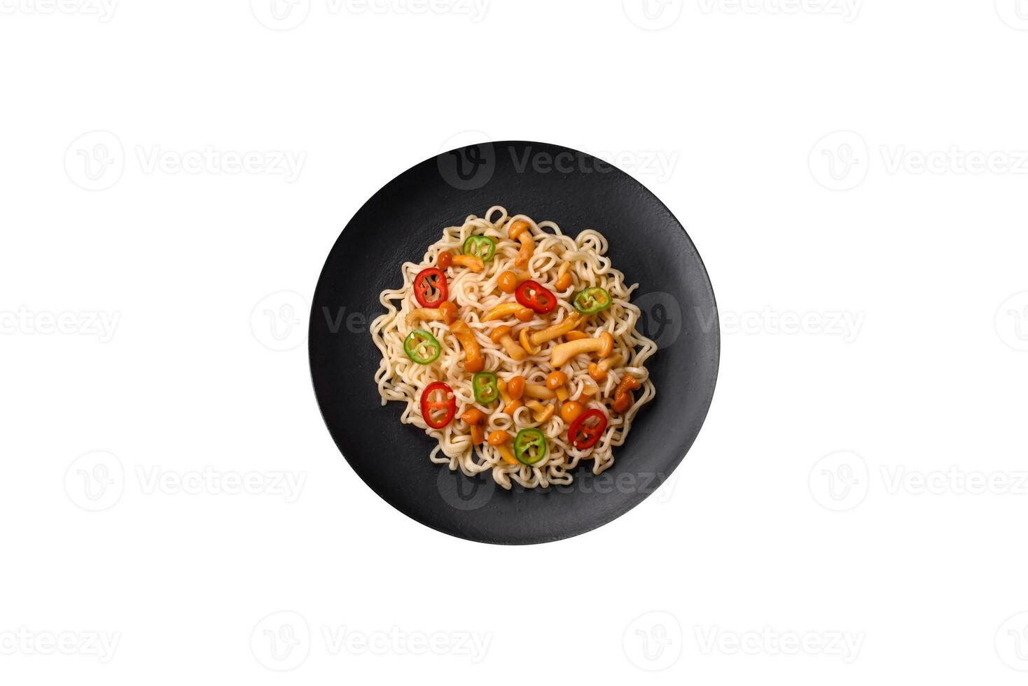 Delicious Asian cuisine dish with rice noodles, peppers, mushrooms and spices photo
