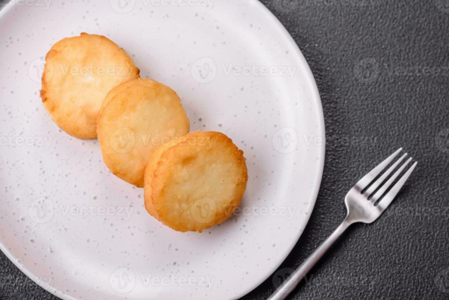 Delicious fresh sweet cheese pancakes with raisins and cinnamon photo
