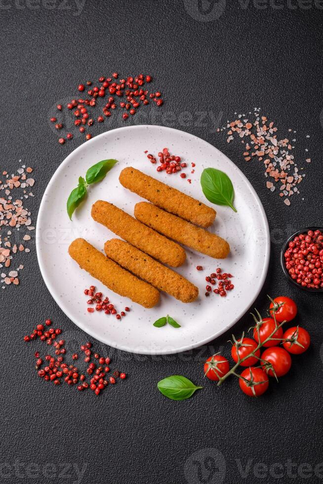 Delicious crispy cheese sticks with mozzarella, salt and spices, breaded and fried in oil photo