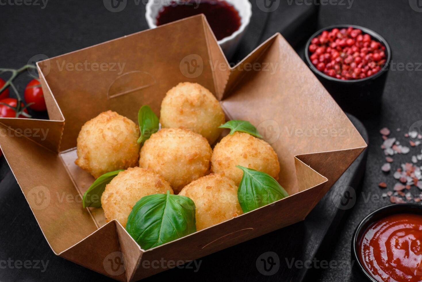 Delicious round balls of mozzarella and parmesan cheese with salt and breaded spices photo