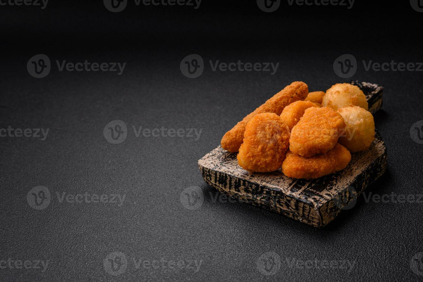 Delicious nuggets, sticks and balls of mozzarella and parmesan cheese with salt and spices photo