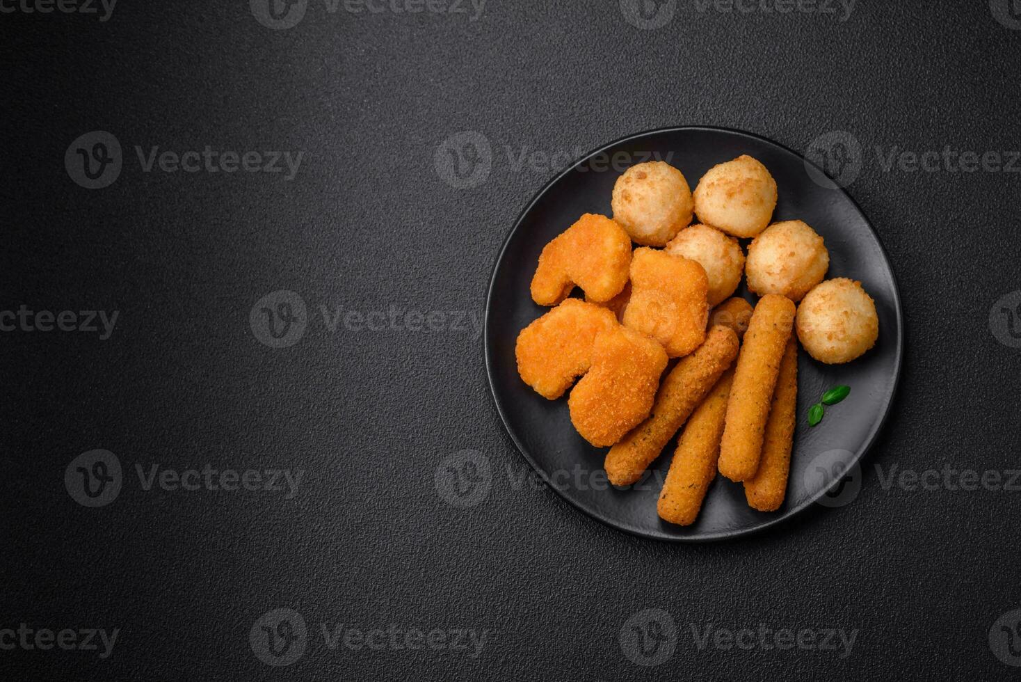 Delicious nuggets, sticks and balls of mozzarella and parmesan cheese with salt and spices photo