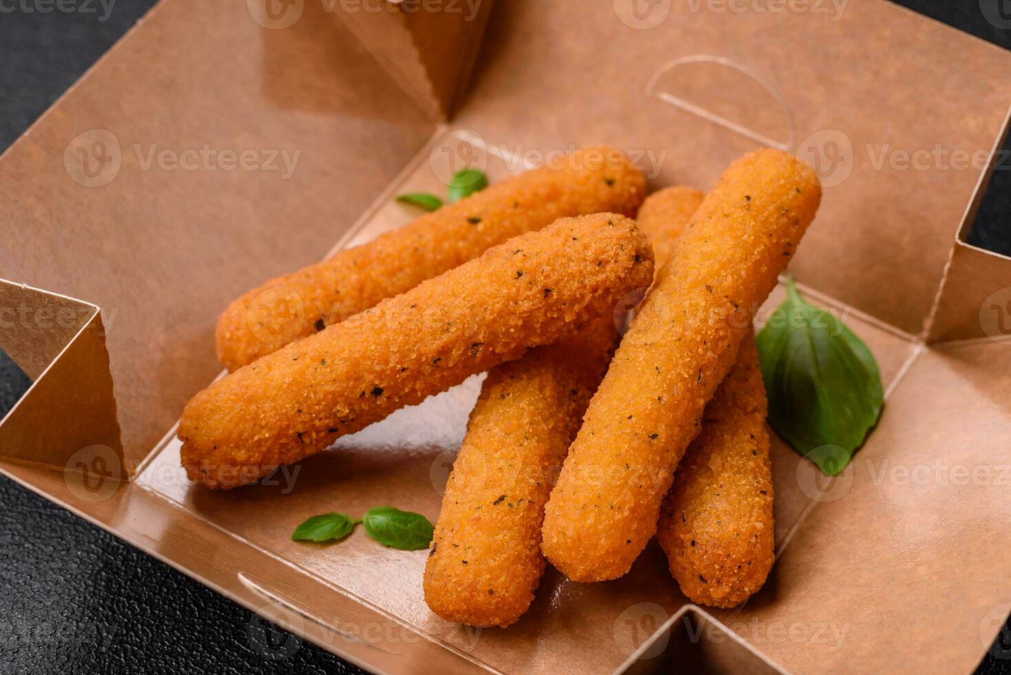 Delicious crispy cheese sticks with mozzarella, salt and spices, breaded and fried in oil photo