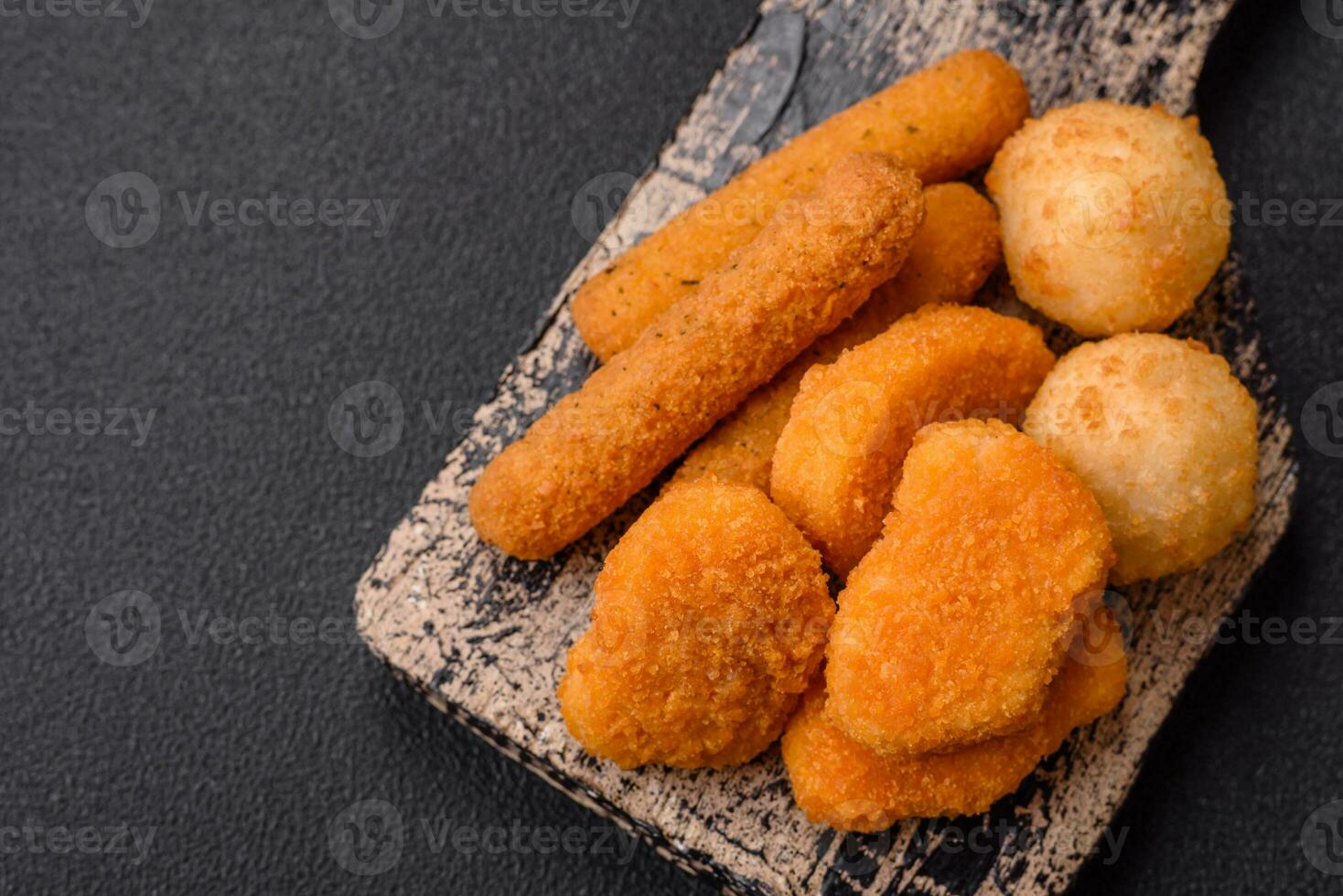 Delicious nuggets, sticks and balls of mozzarella and parmesan cheese with salt and spices photo