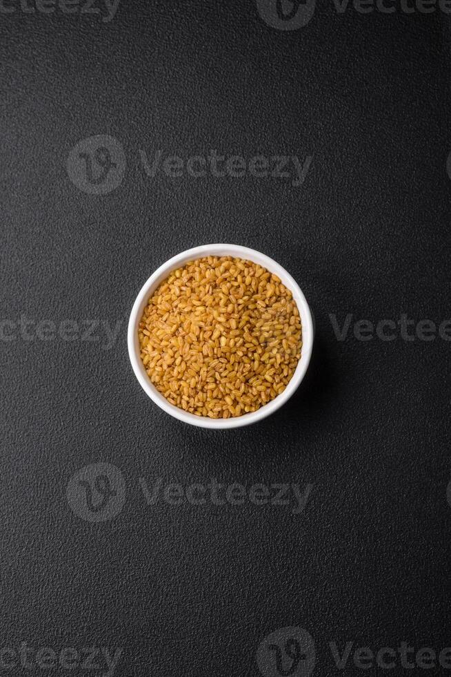 Raw bulgur wheat porridge as an ingredient for preparing a delicious dish photo