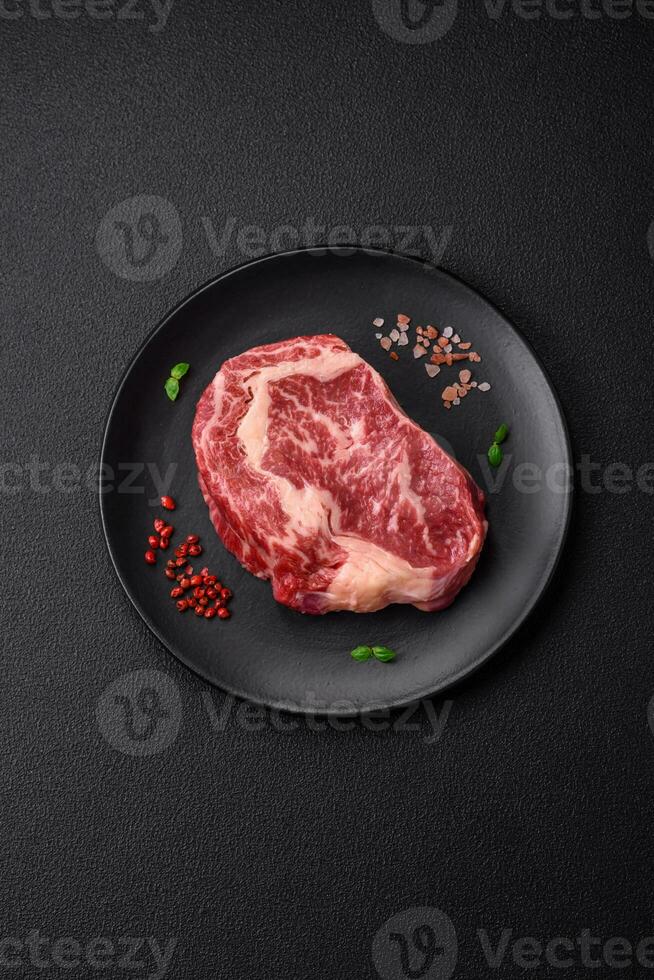 Fresh juicy raw beef striploin steak with salt and spices photo