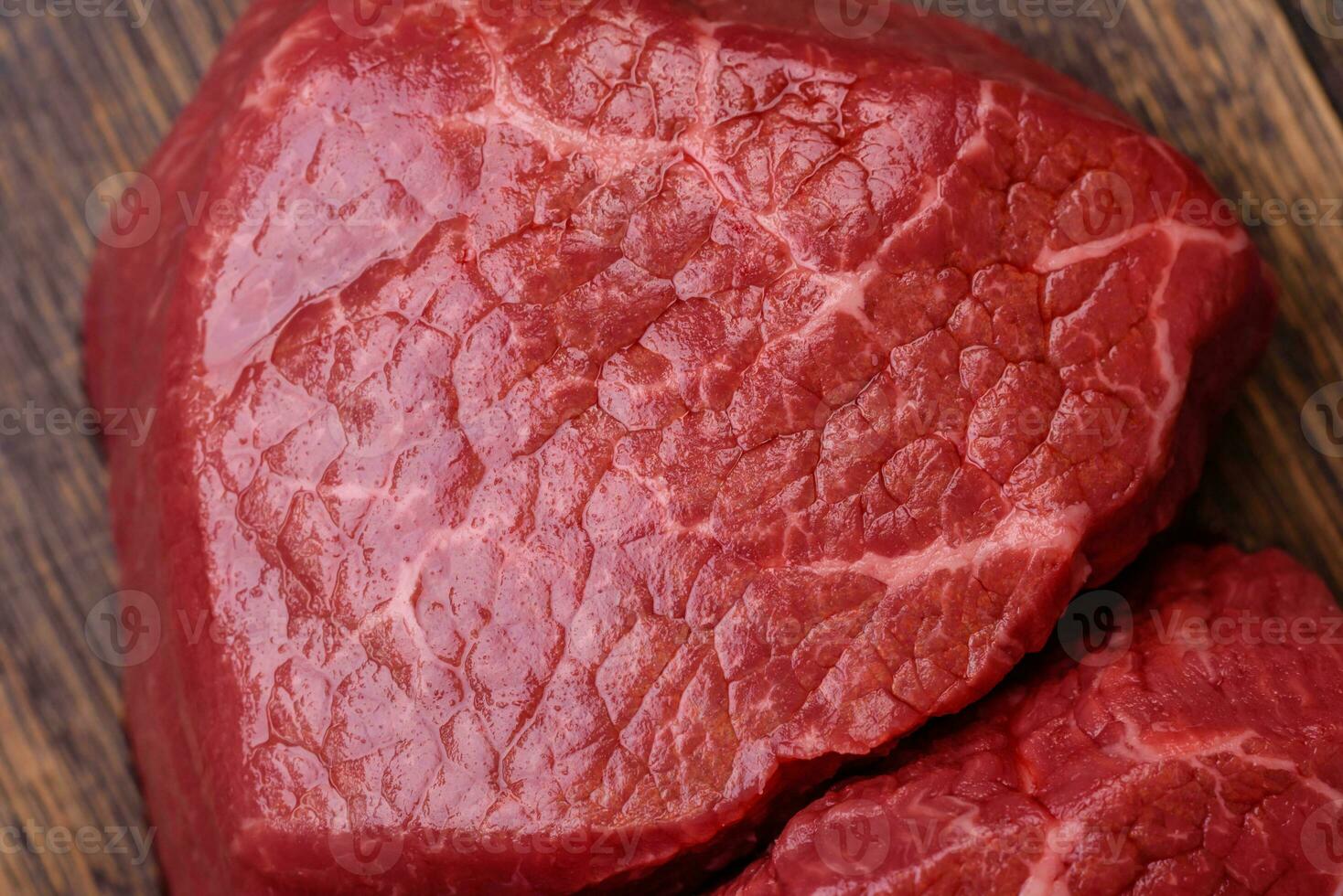 Fresh juicy raw beef medallions with salt and spices photo
