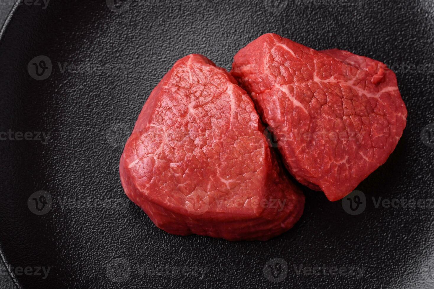 Fresh juicy raw beef medallions with salt and spices photo