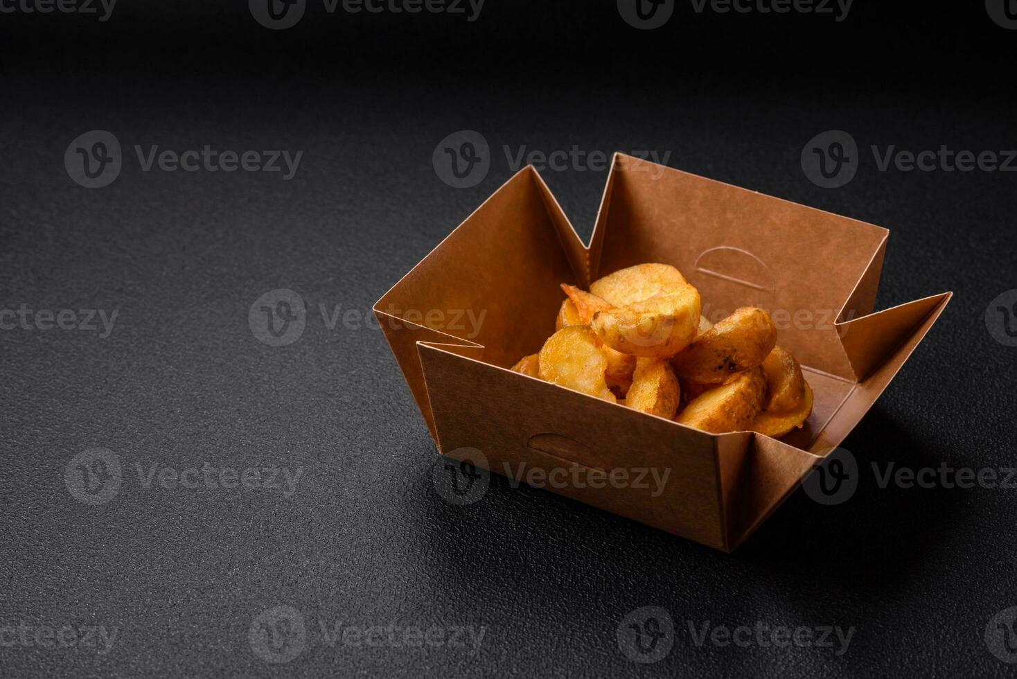 Delicious crispy fried potato wedges with salt, spices and herbs photo