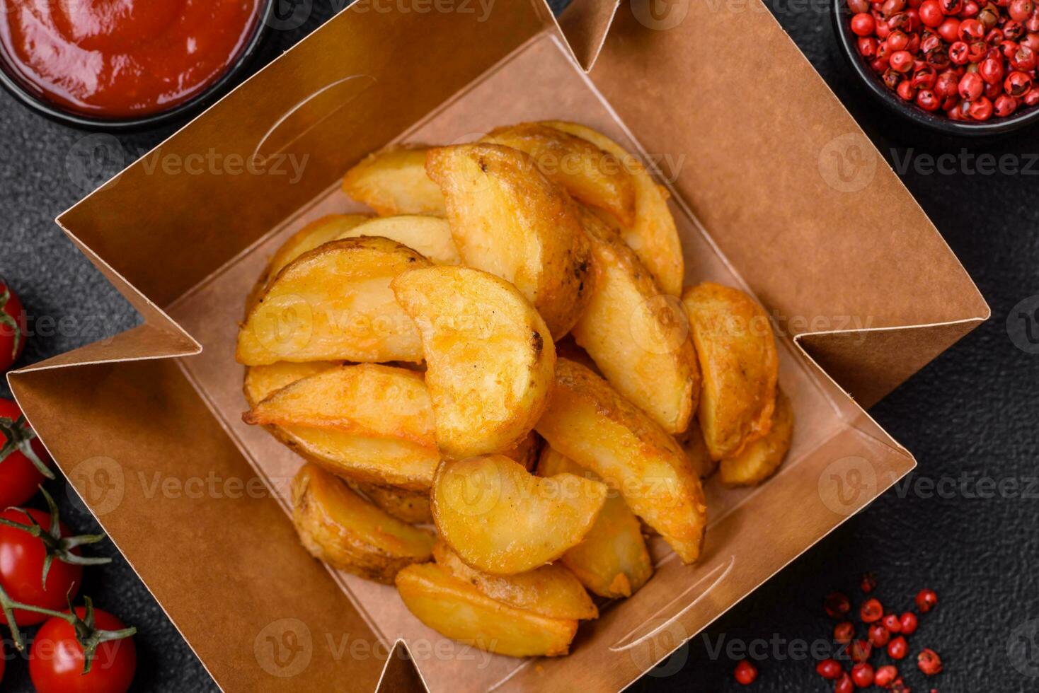 Delicious crispy fried potato wedges with salt, spices and herbs photo