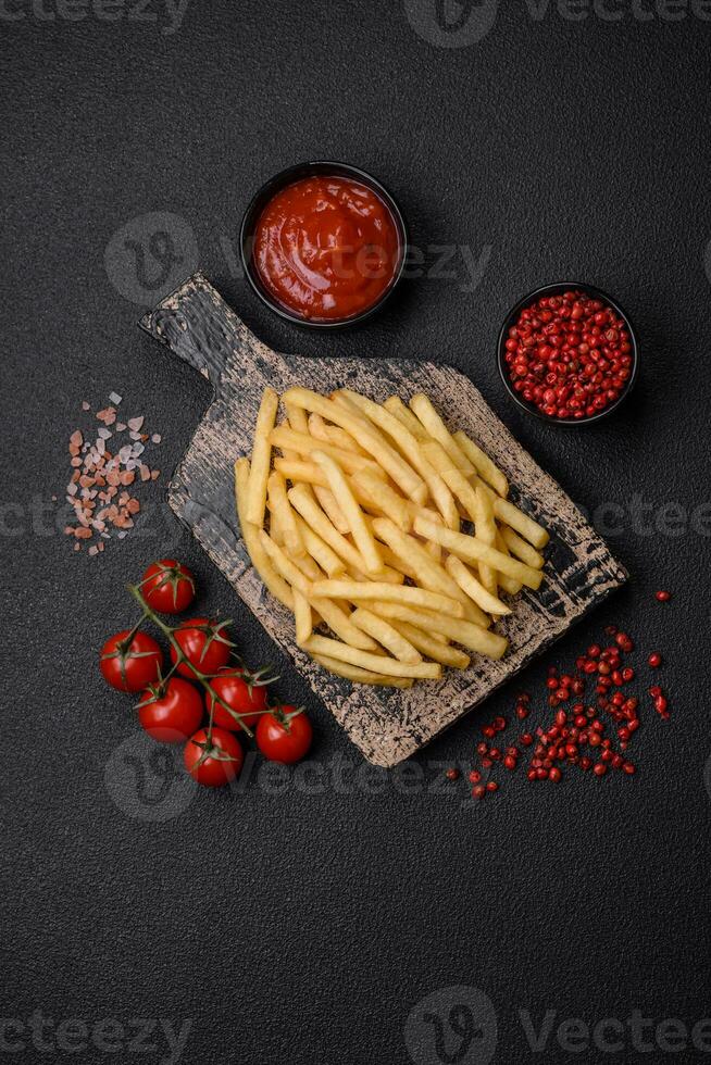 Fresh delicious crispy French fries with salt and spices photo