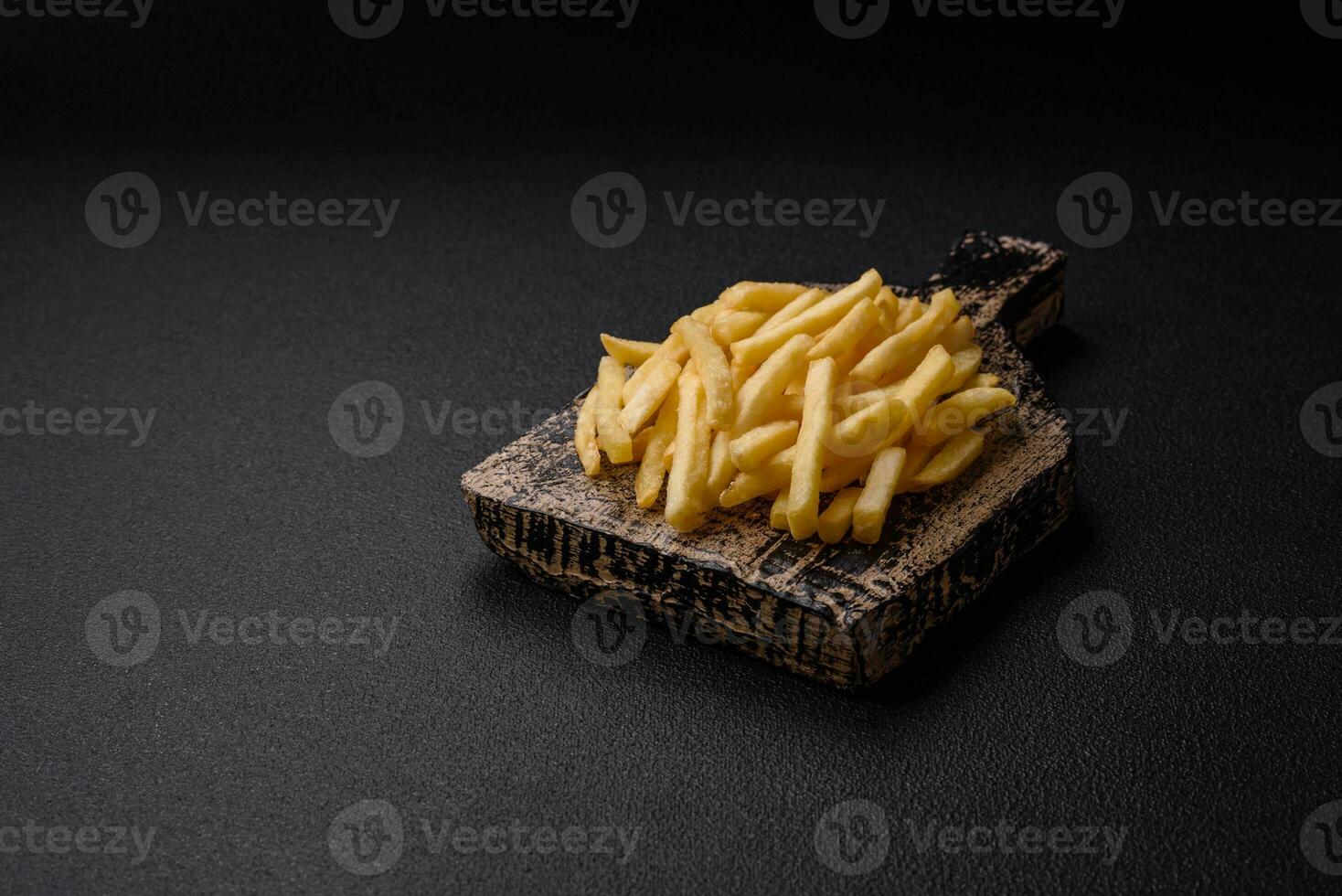 Fresh delicious crispy French fries with salt and spices photo