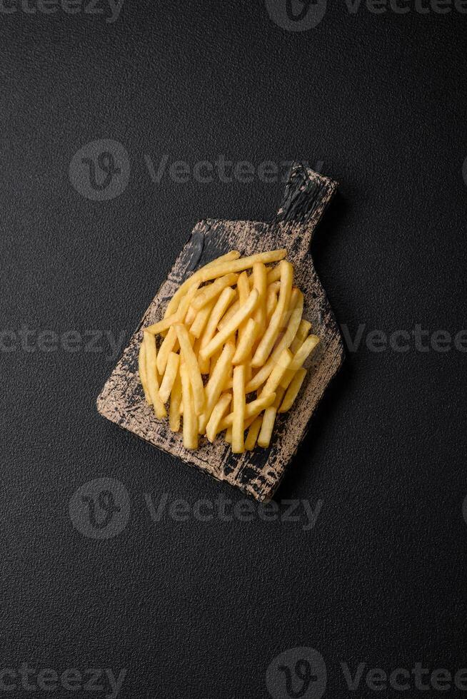 Fresh delicious crispy French fries with salt and spices photo