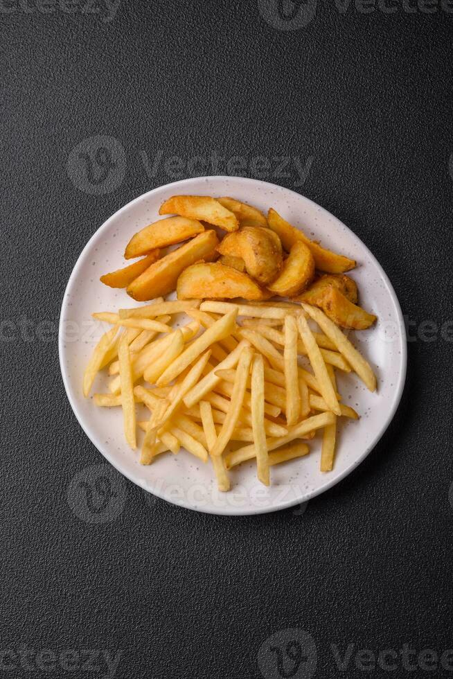 Fresh delicious crispy French fries with salt and spices photo