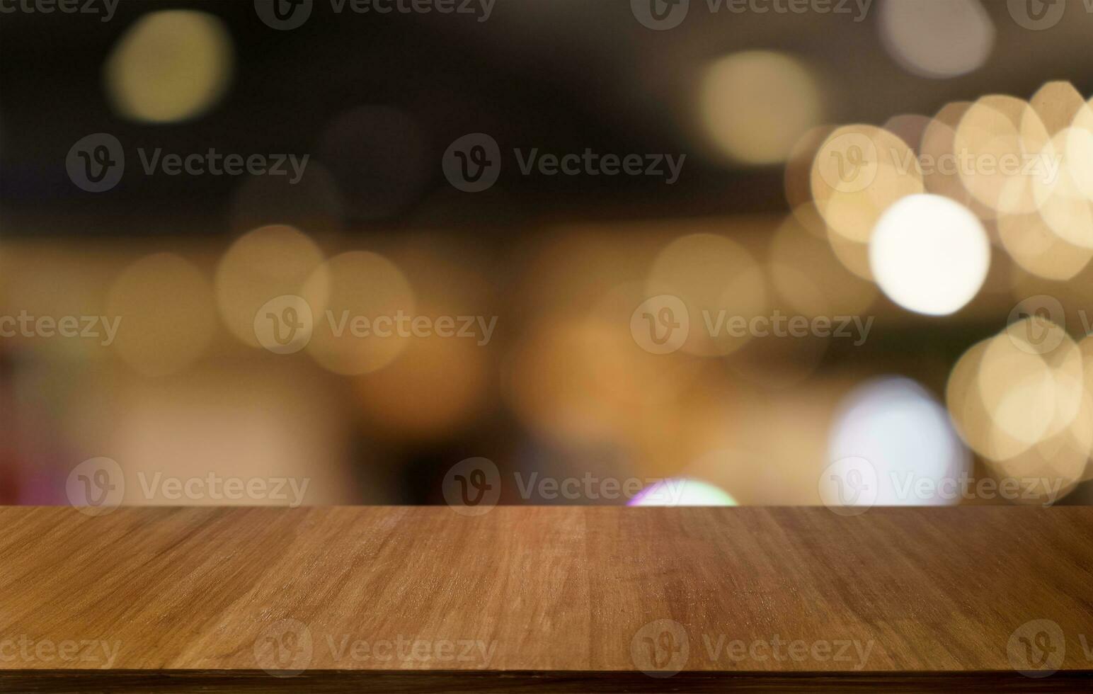 Mock up for space. Empty dark wooden table in front of abstract blurred bokeh background of restaurant . can be used for display or montage your product photo