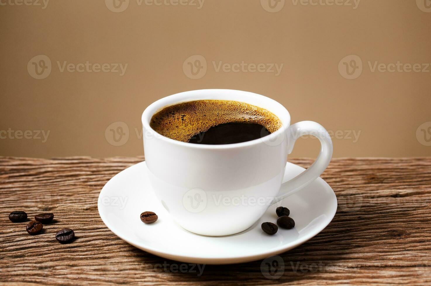 coffee cup on old wooden table with cream wall background. photo