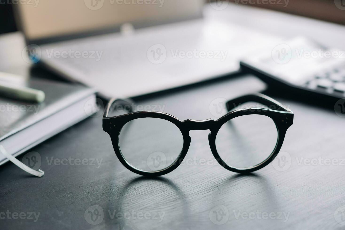 Professional Workspace. Glasses, Calculator, Laptop, Office Desk for Finance, Accounting, Tax, Savings, Business Planning. photo