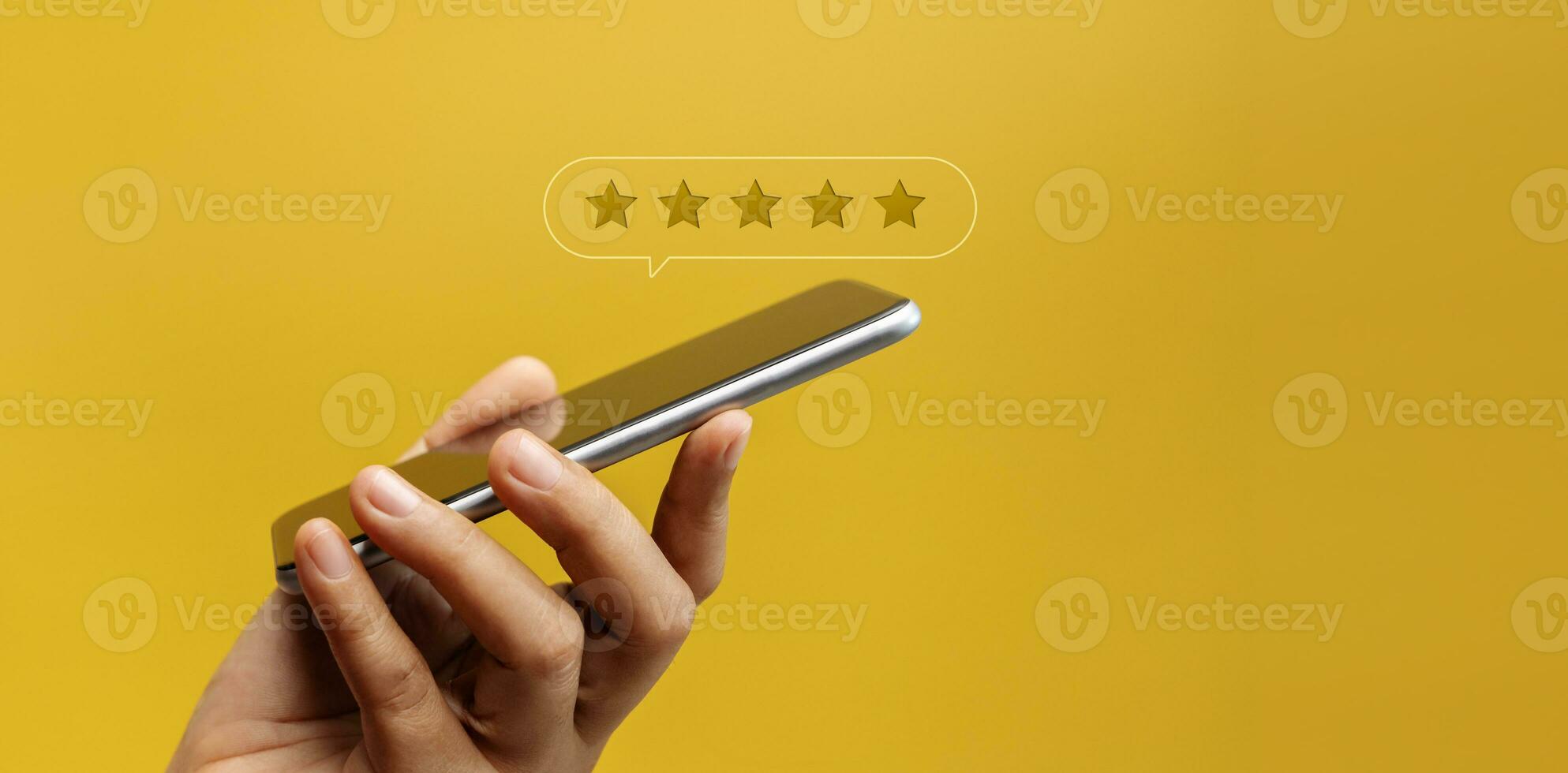 Customer Experiences Concept. Happy Client Using Smartphone to Submit Five Star Review Rating for Online Satisfaction Surveys. Positive Feedback on Mobile Phone photo