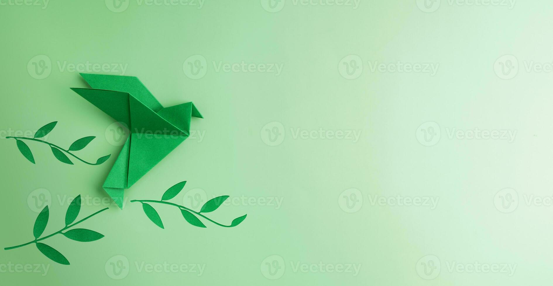 Peace and New Beginnings of Hope. A Green Dove Flying over green Olive Branch. World International Peace Day. The Concept of a Fluttering Bird that brings Peaceful to the World photo