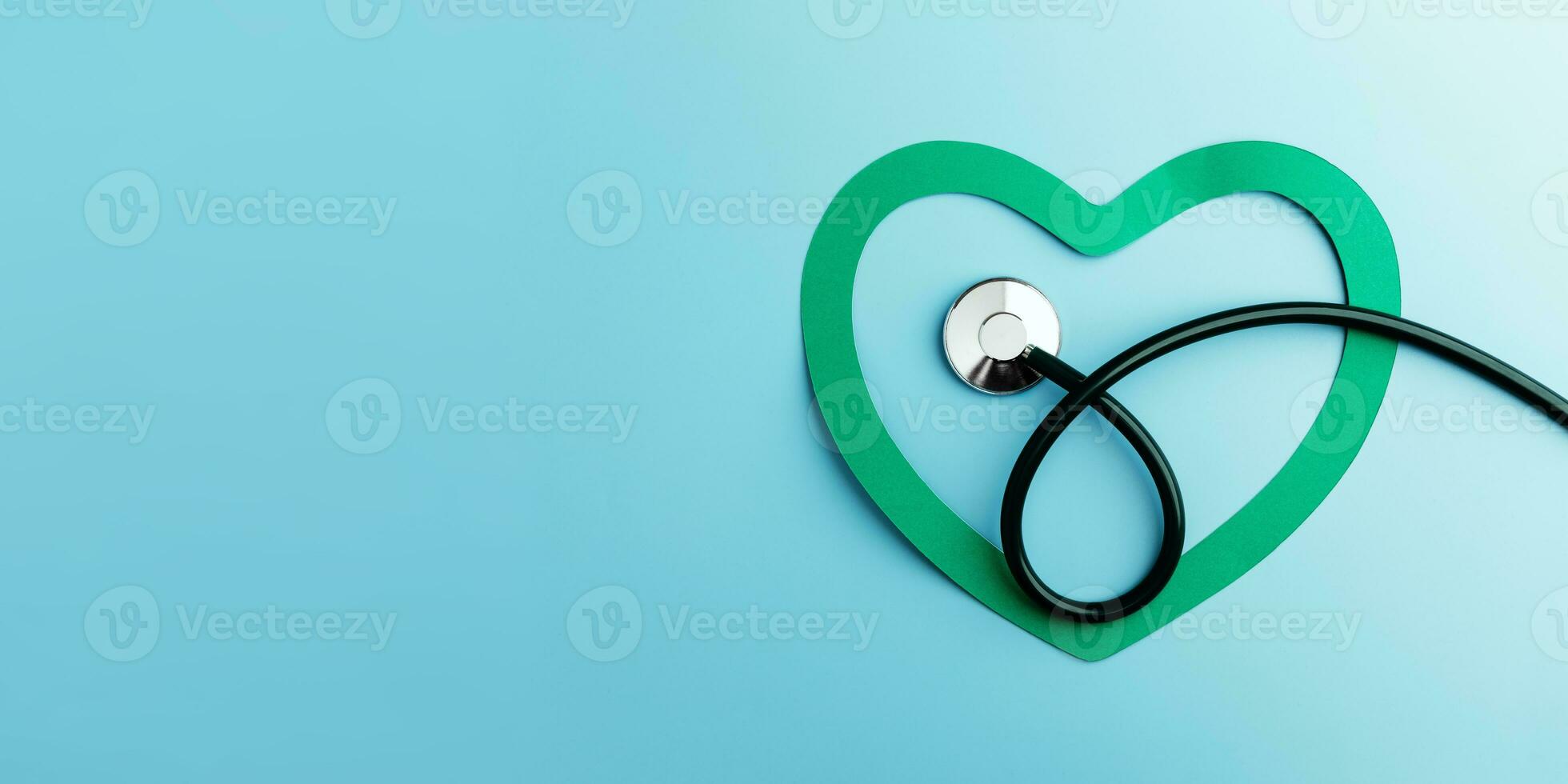 Health Care Awareness Concept. International World Heart Day. Paper Cut as Heart Shape with Stethoscope in Top View. Life, Love and Care for Heart and Cardiovascular photo