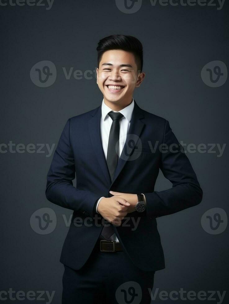 Smiling young man of Asian descent dressed in suit on gray background AI Generative photo