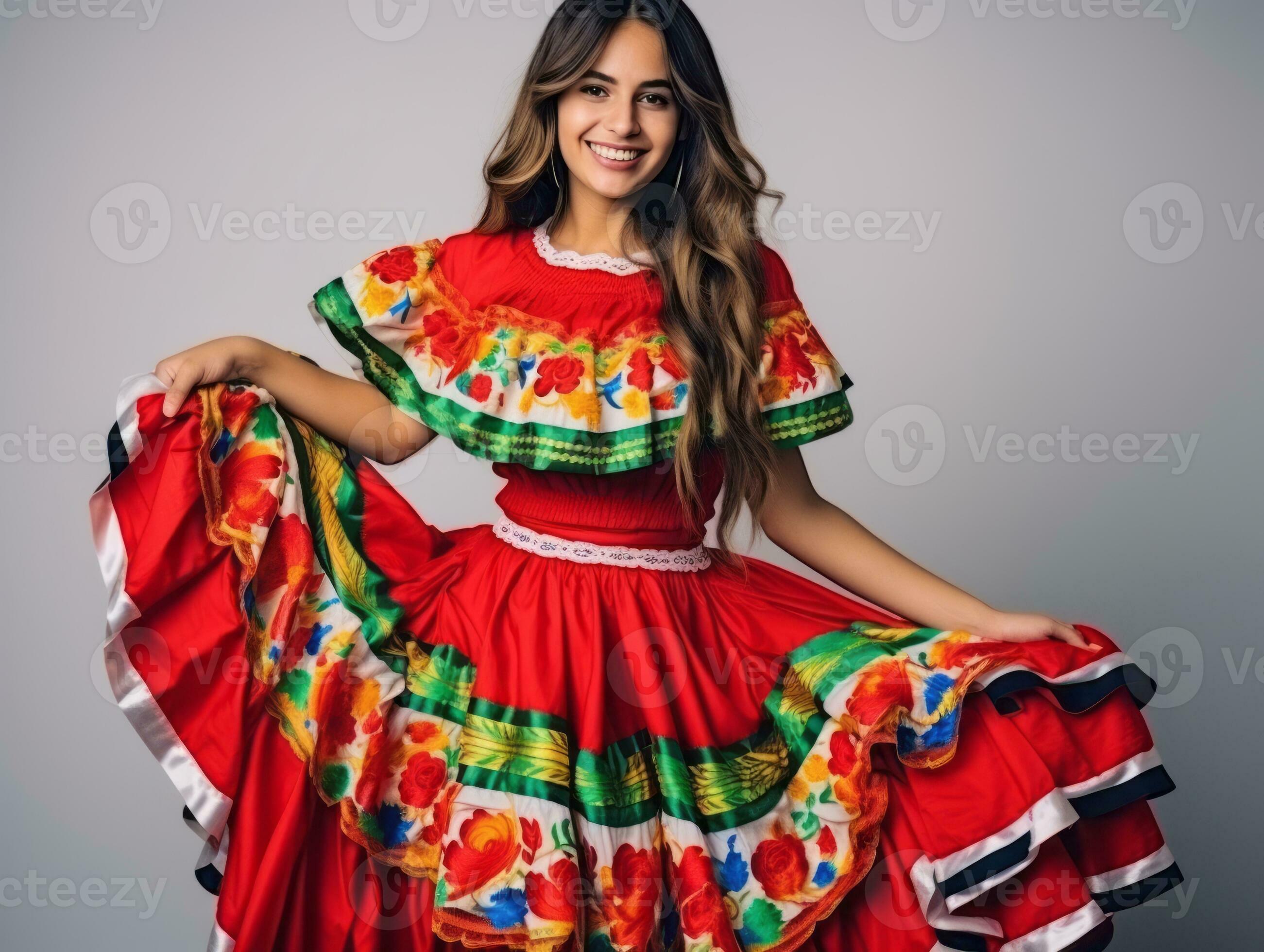 Smiling young woman of Mexican descent dressed in elegant dress on gray