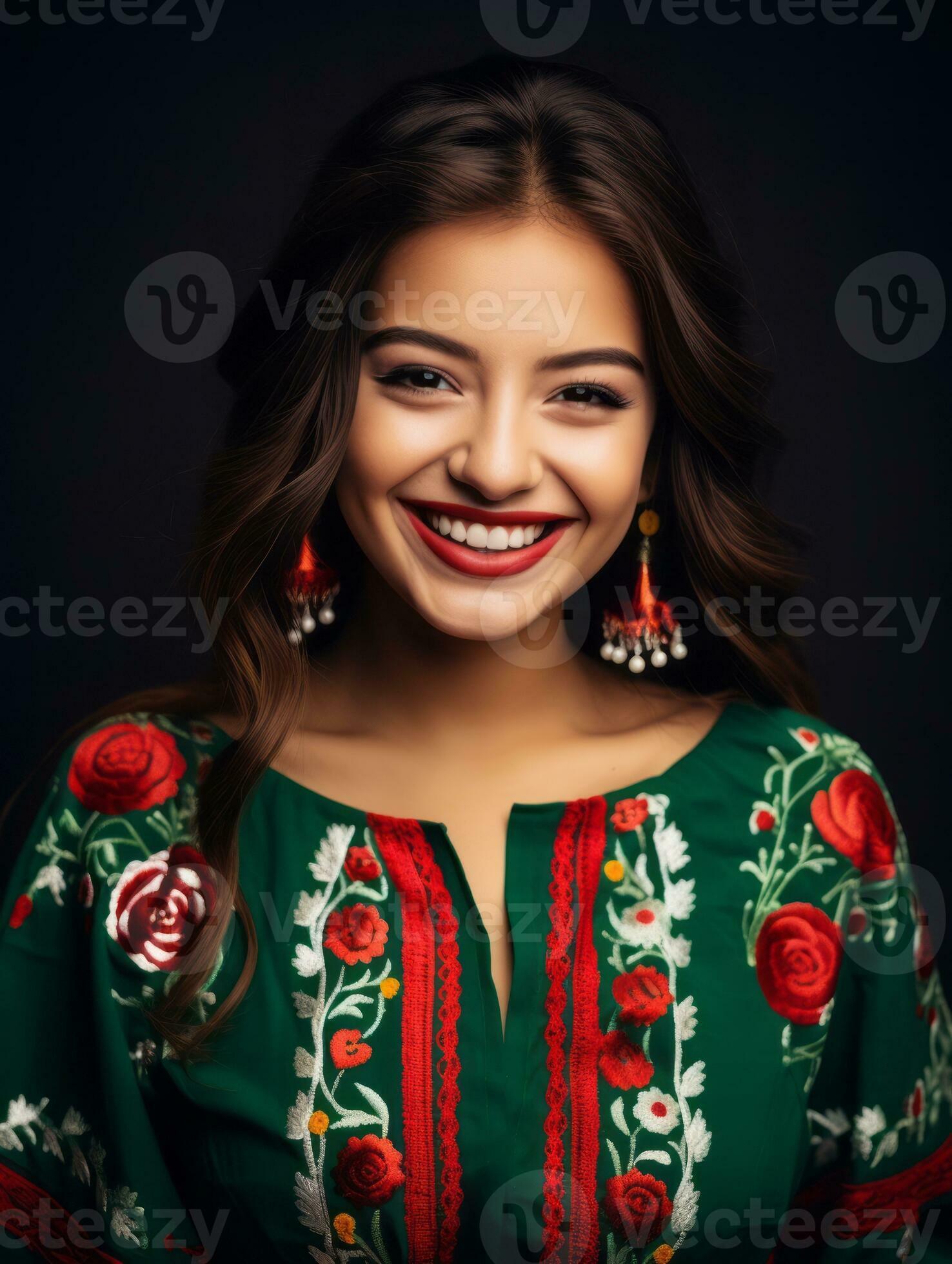 Smiling young woman of Mexican descent dressed in elegant dress on gray