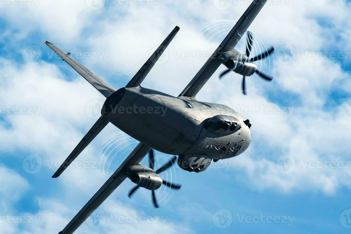 Untitled military transport plane at air base. Airport and airfield. Air force and army flight operation. Aviation and aircraft. Air lift. Military industry. Fly and flying. photo