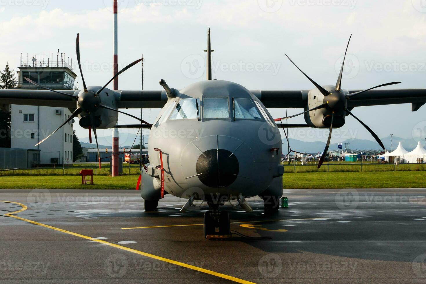 Untitled military transport plane at air base. Airport and airfield. Air force and army flight operation. Aviation and aircraft. Air lift. Military industry. Fly and flying. photo