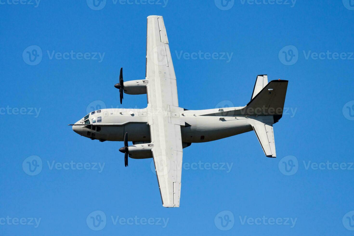 Untitled military transport plane at air base. Airport and airfield. Air force and army flight operation. Aviation and aircraft. Air lift. Military industry. Fly and flying. photo