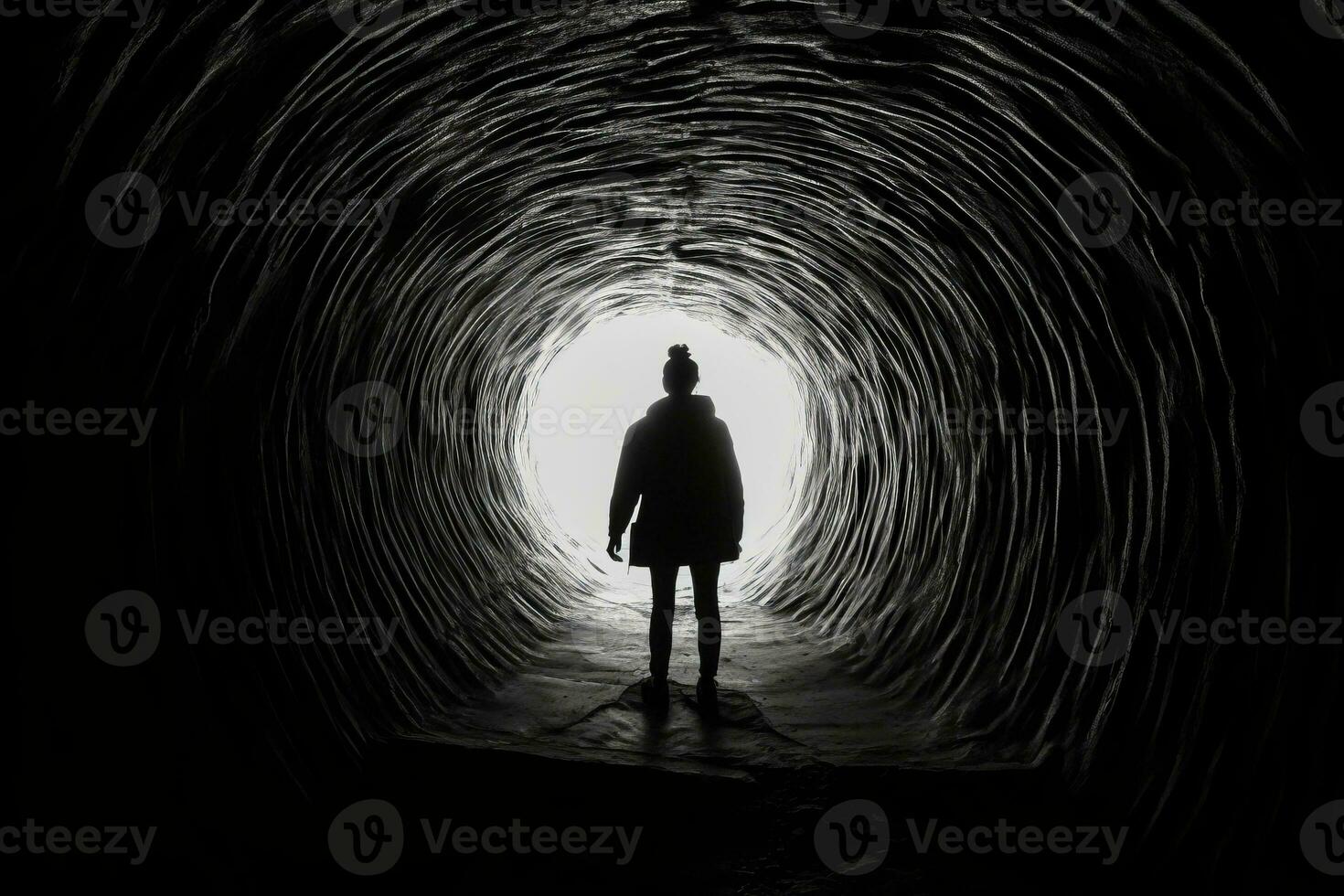 An image of a person emerging from a dark tunnel towards the light