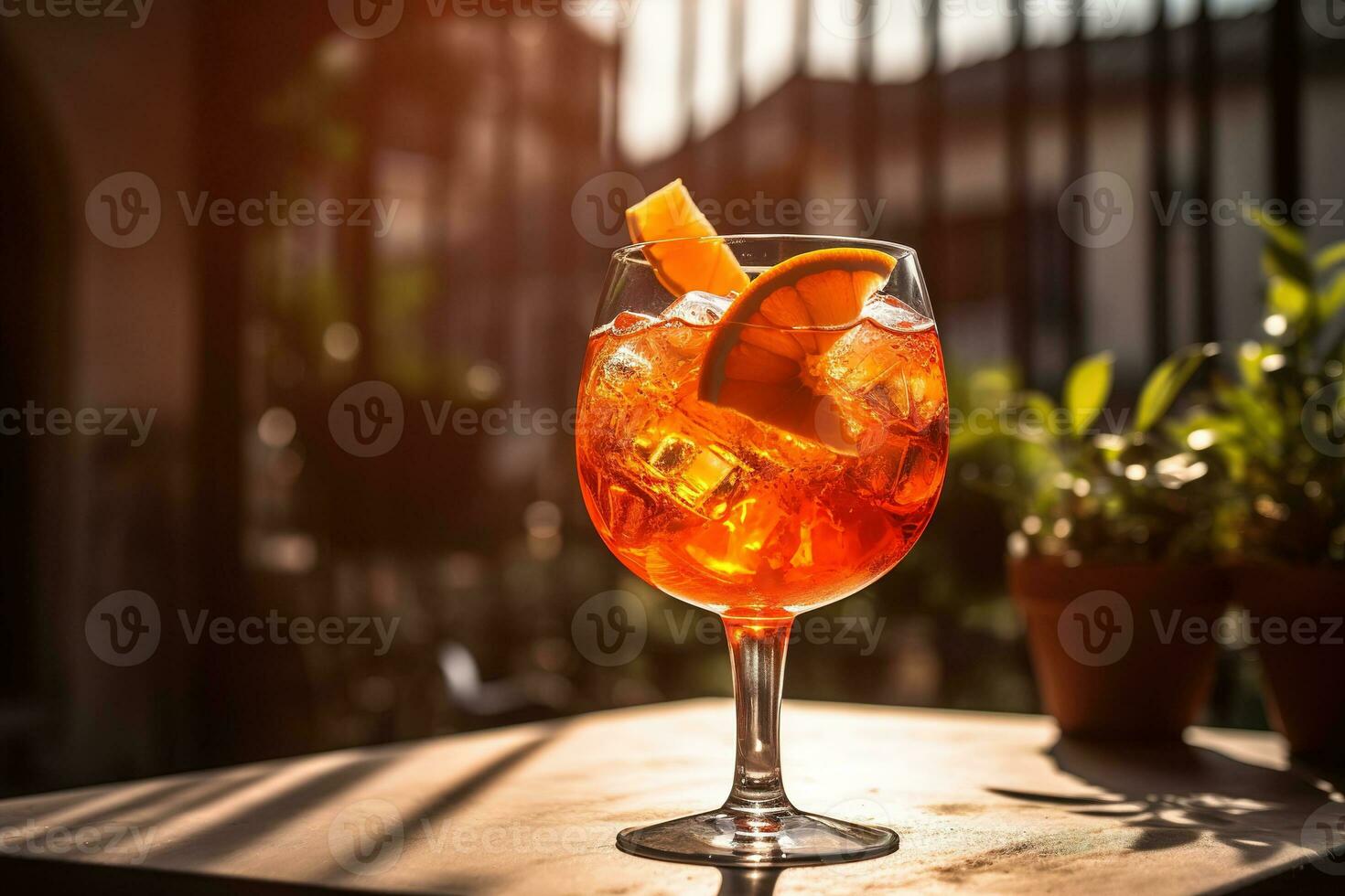 A refreshing, summery Aperol Spritz, served in a wine glass with ice, a splash of soda, and garnished with a slice of orange, set against a sunlit outdoor terrace. Generative AI. photo