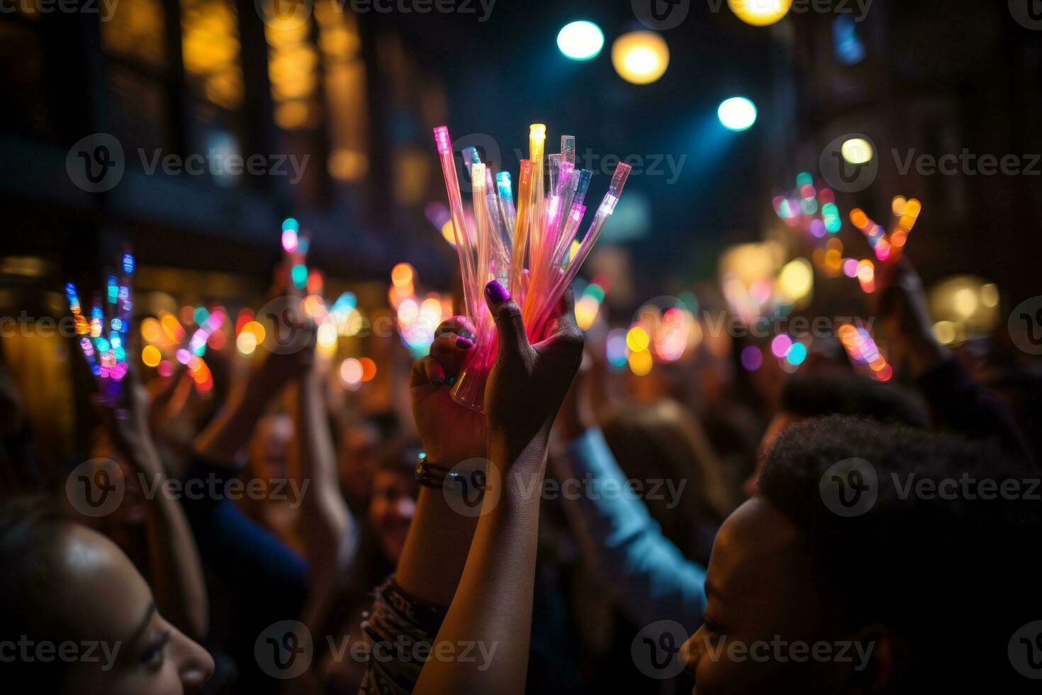 A close-up shot of hands holding glow sticks in the air at a rave party with a blurry crowd of people dancing in the background. Generative AI photo