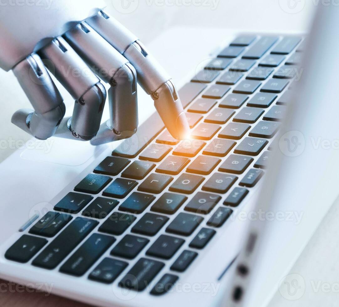 Artificial intelligence concept, robot hand keys computer photo