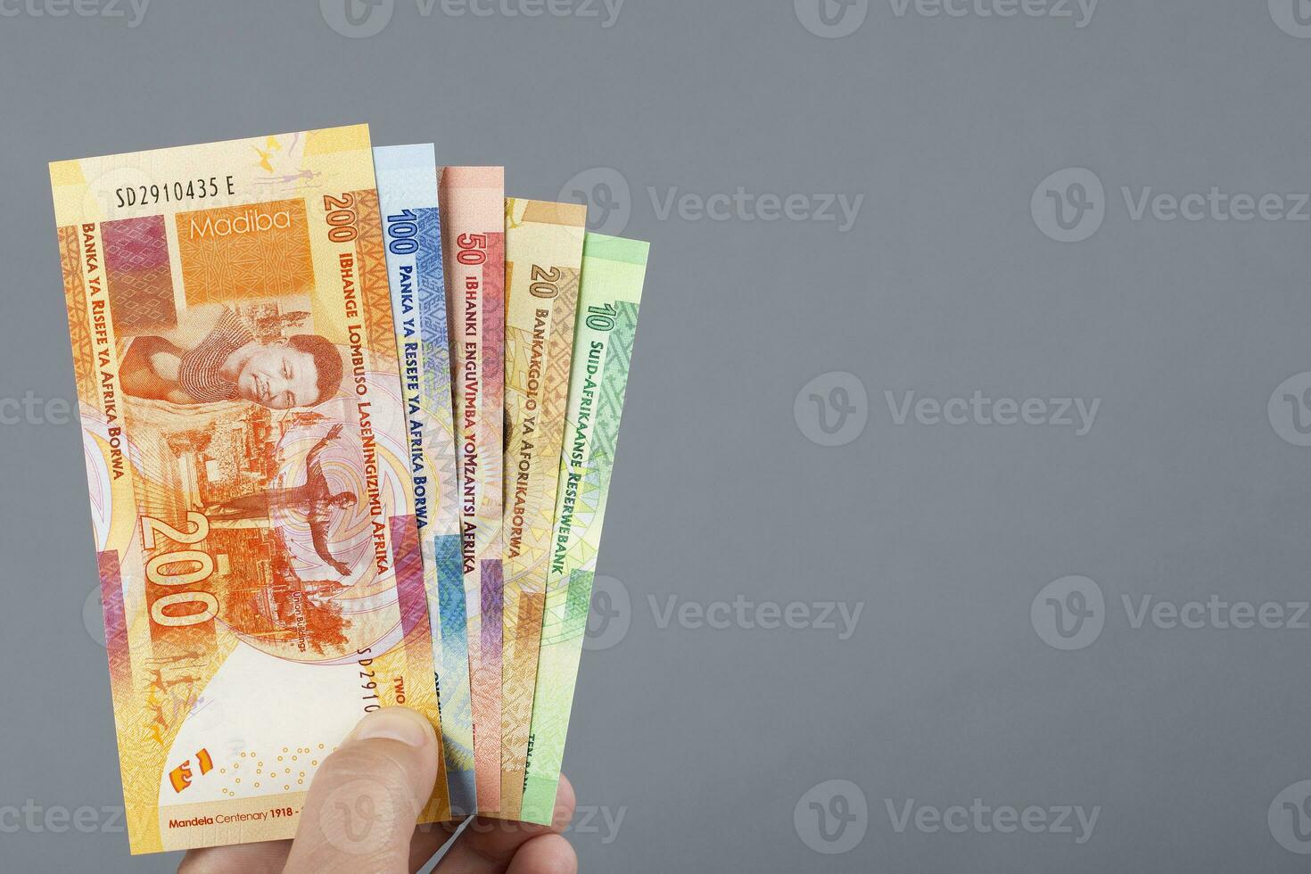 South African money in the hand on a gray background photo