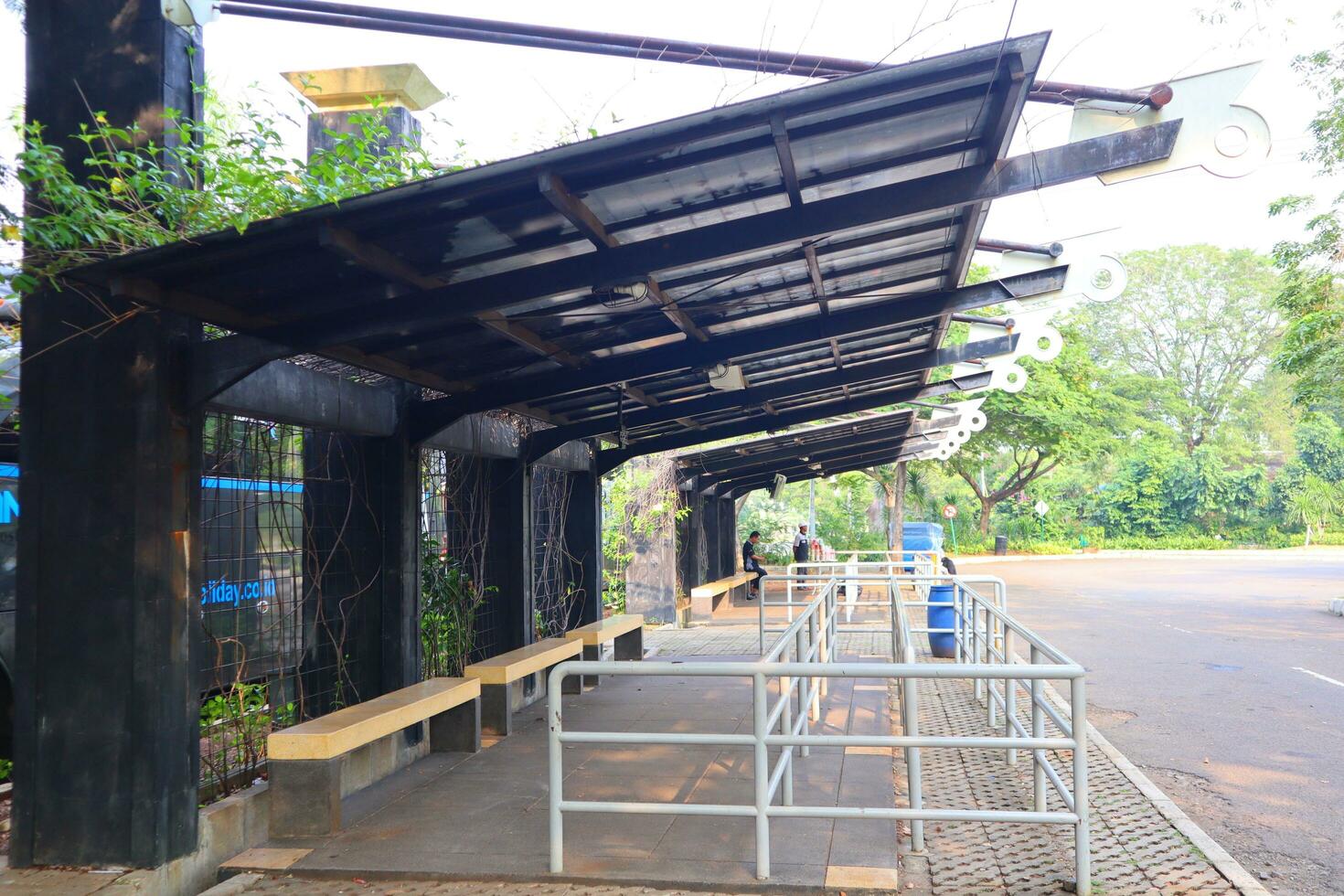 empty bus stop. midday. no vehicles photo