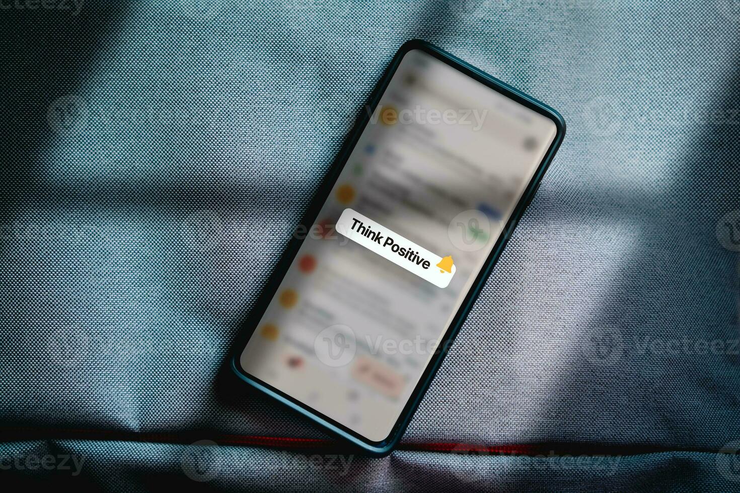 Top view photo of smartphone with think positive quote notification on screen. Mental health assessment. Happiness. Feelings. World mental health concept.