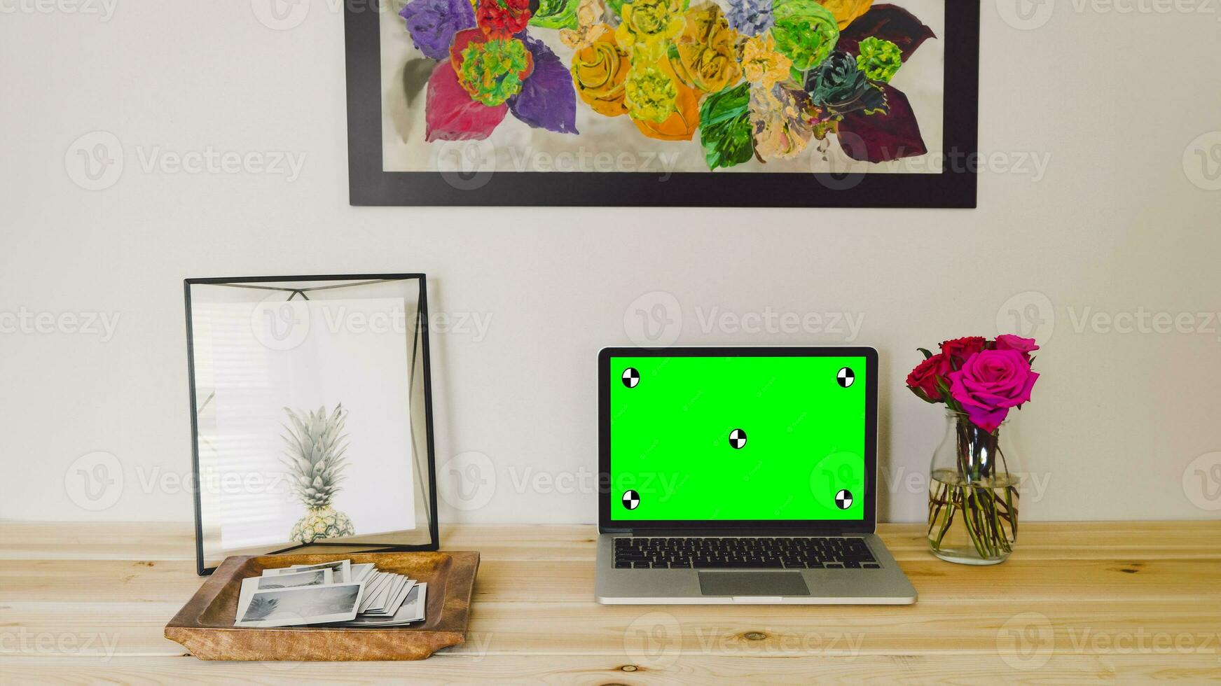 Workplace with laptop computer on desk with blank empty green mockup screen for advertising standing in modern contemporary office. Business software website ads technology concept. photo