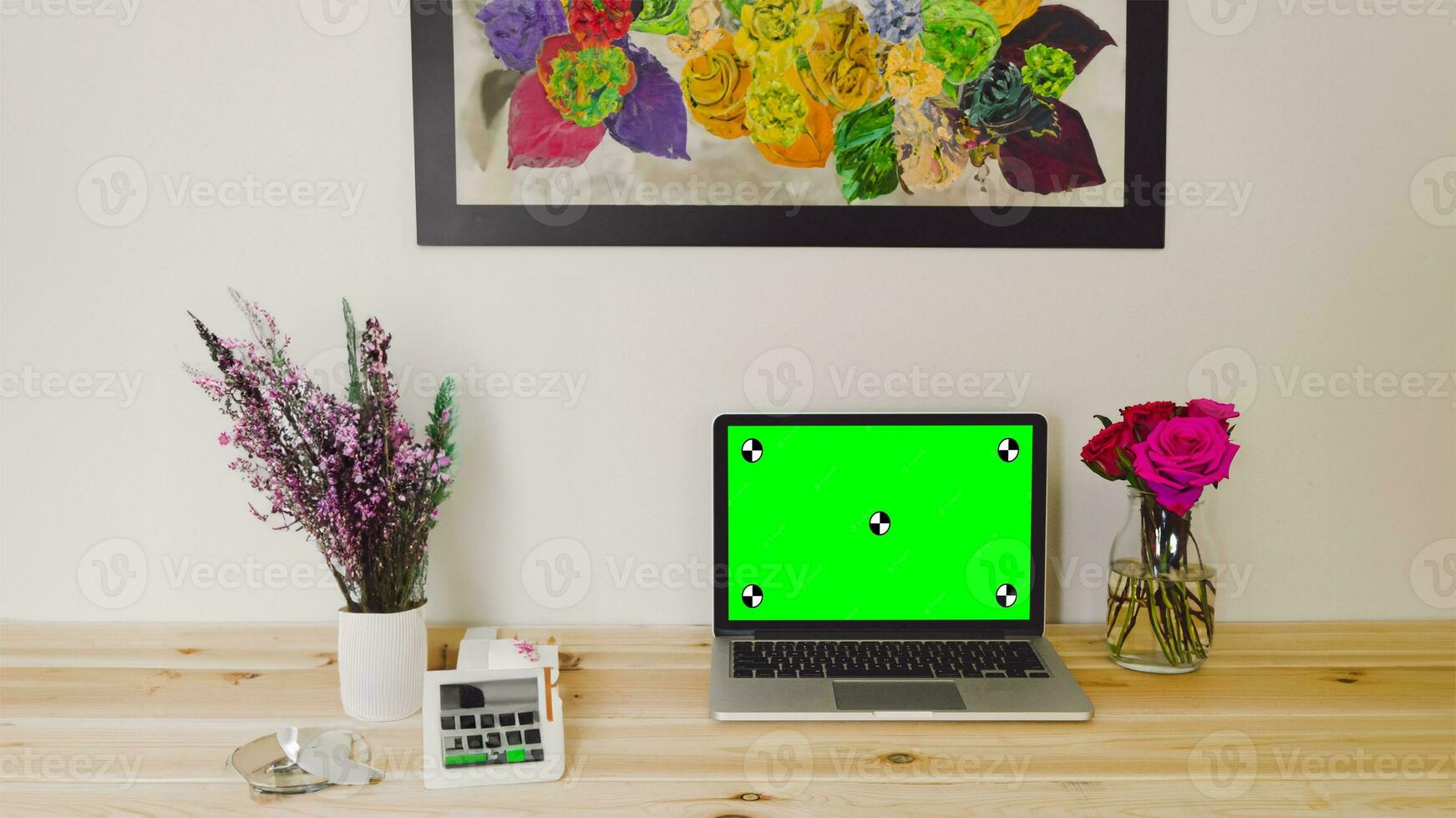 Workplace with laptop computer on desk with blank empty green mockup screen for advertising standing in modern contemporary office. Business software website ads technology concept. photo