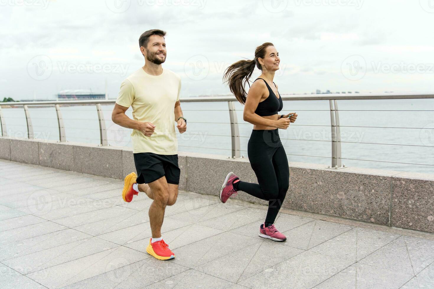 A woman and a man doing sports running. Friends run together. Fitness exercises for a healthy lifestyle. Running fast in full height in the fresh air. Sports people, training together. photo