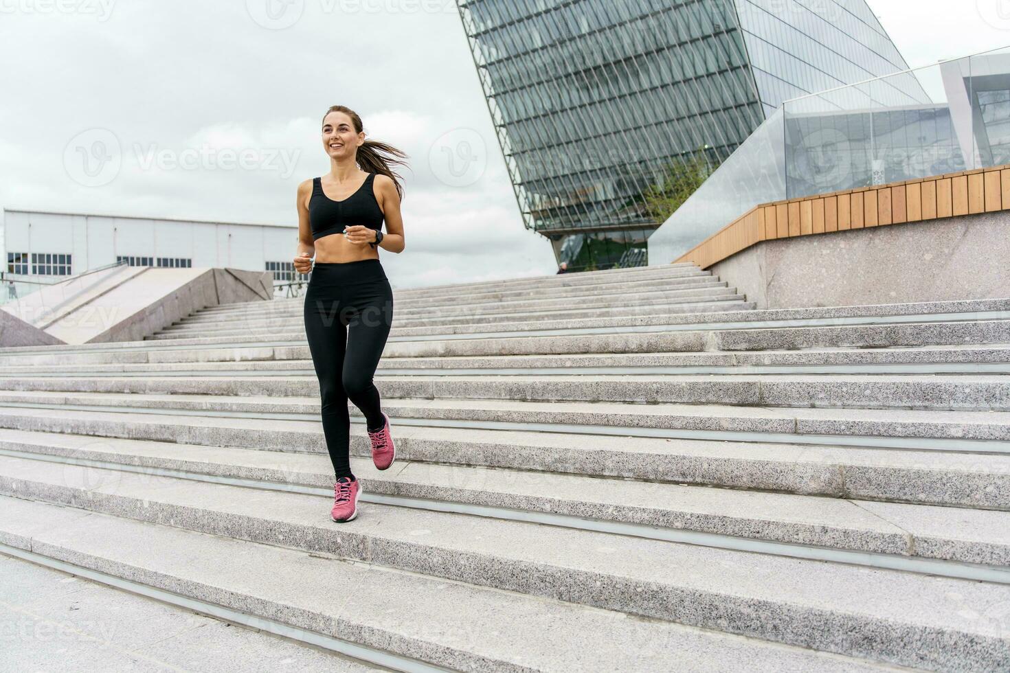 A person is a runner using a smartwatch for fitness, sportswear and running shoes. Motivation women engaged in fitness train.    Athlete training plank in sportswear. photo