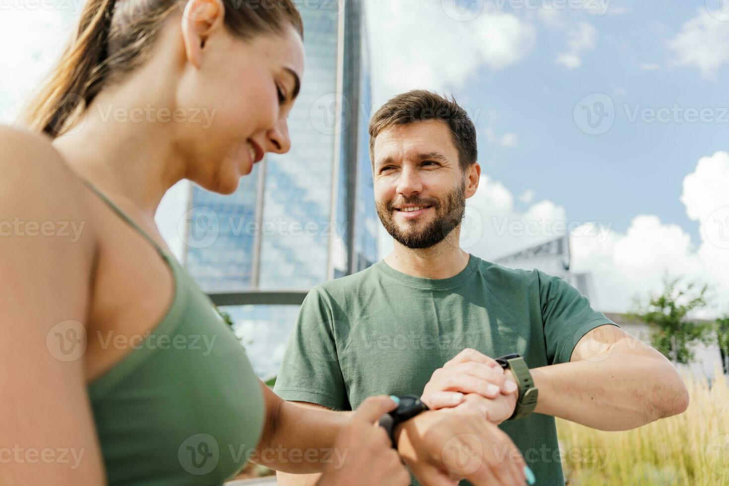 Workout people use fitness watch and app for exercise results. A woman and a man in fitness clothes for running. Physical education together, family couple healthy lifestyle. photo