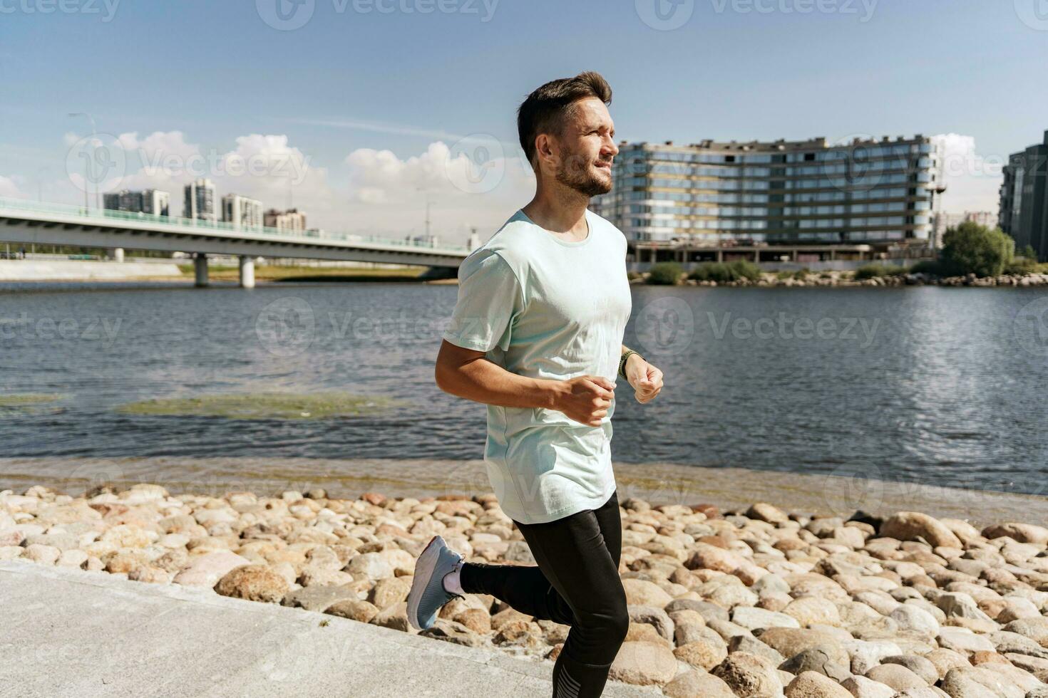 A runner does exercise every day, a healthy lifestyle. A man training fitness in a comfortable T-shirt. A sporty man jogging in sneakers. photo