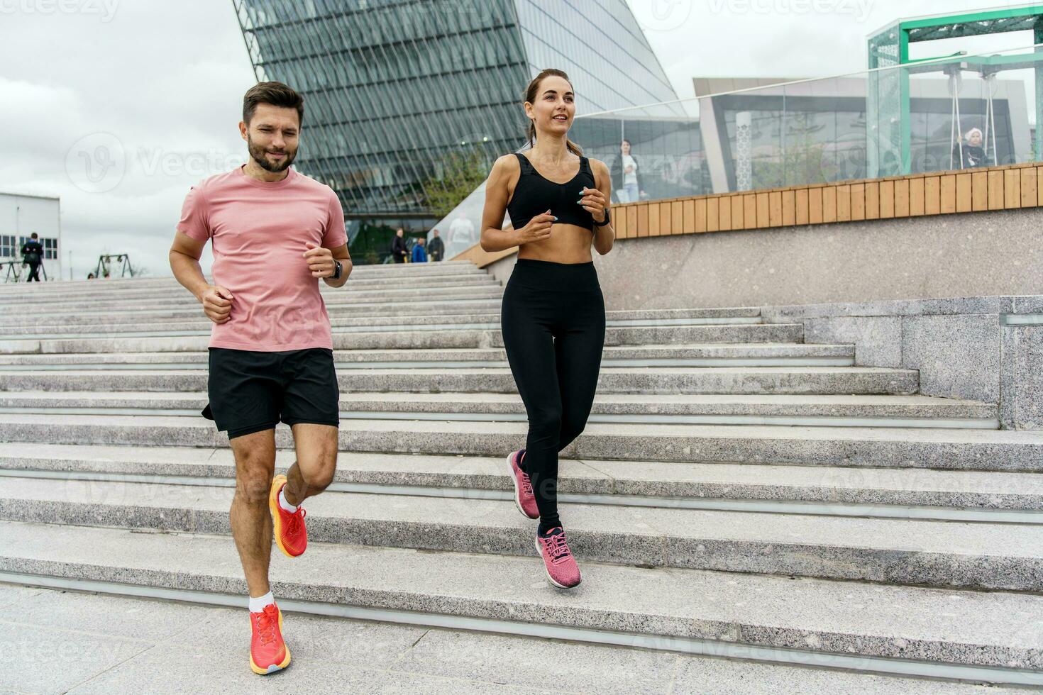 A woman and a man in fitness running clothes. Physical education together, family couple healthy lifestyle. People workout trainer use fitness watch and app for exercise results. photo