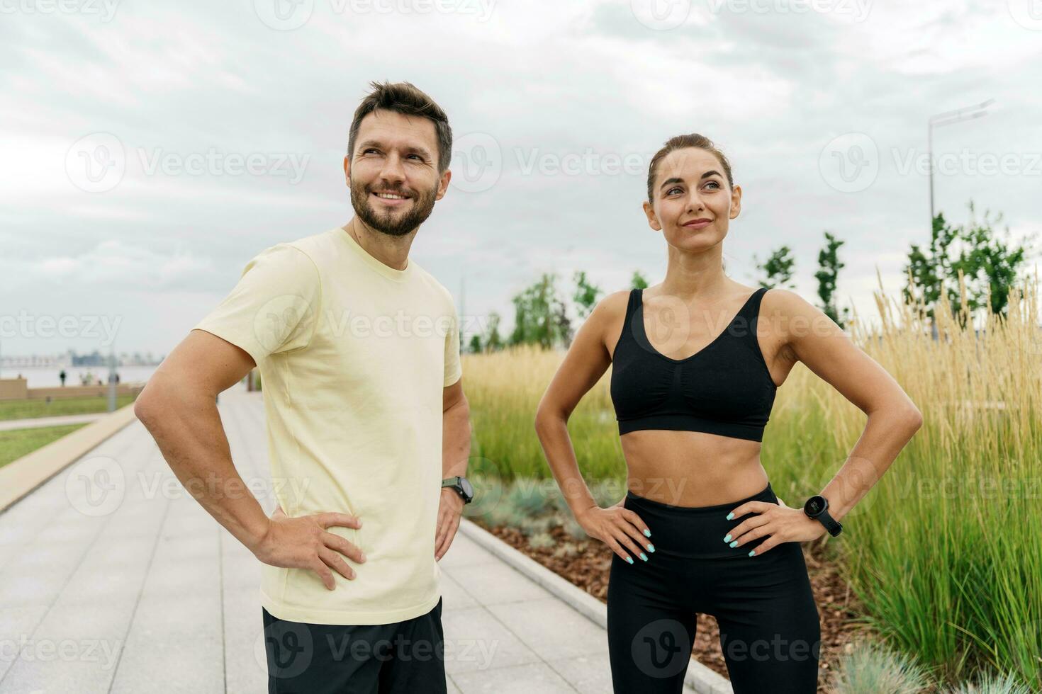 Athletes couple training plank in sportswear.  Motivation friends doing fitness work out together. People using smart watches for fitness, sportswear and running shoes. photo