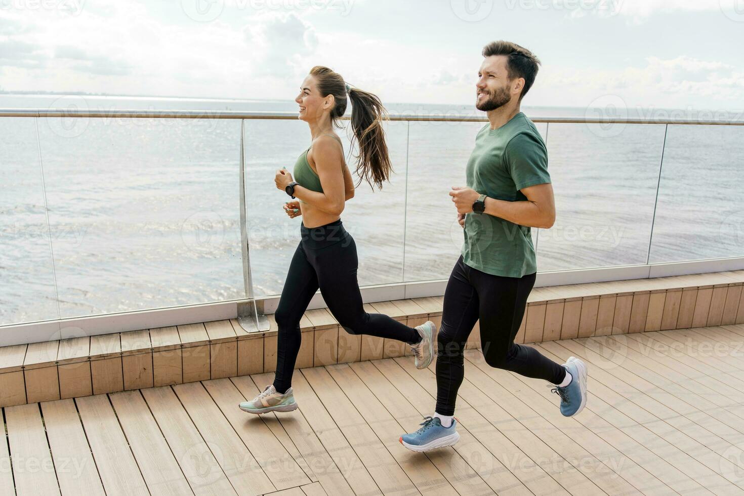 People in sportswear together, physical education and sports. Athletic man and woman train in fitness and running. Using smart watches and a fitness app.    Team exercises of a young couple. photo