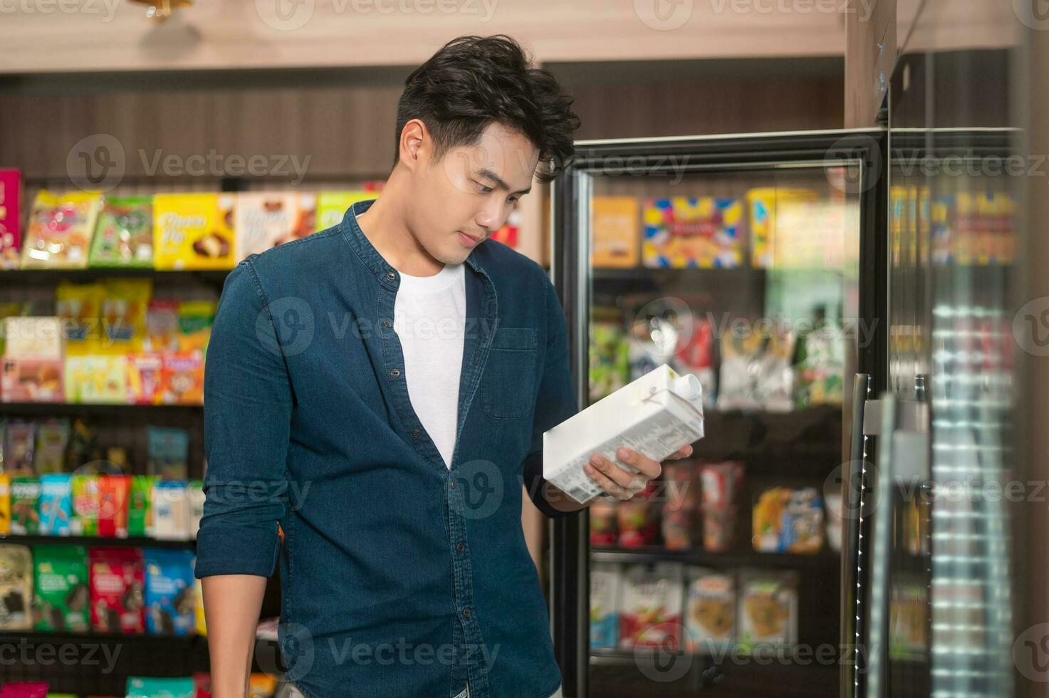 A young asian man shopping in supermarket , concept of city life lifestyle photo