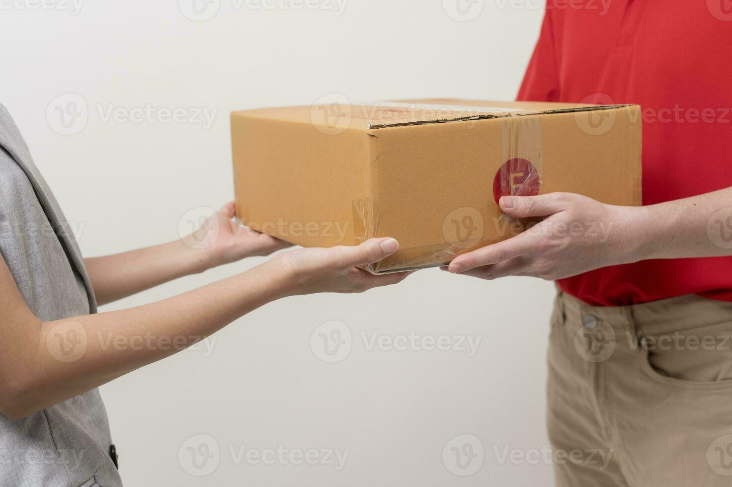 Asian man delivery sending cardboard box to woman over white background photo