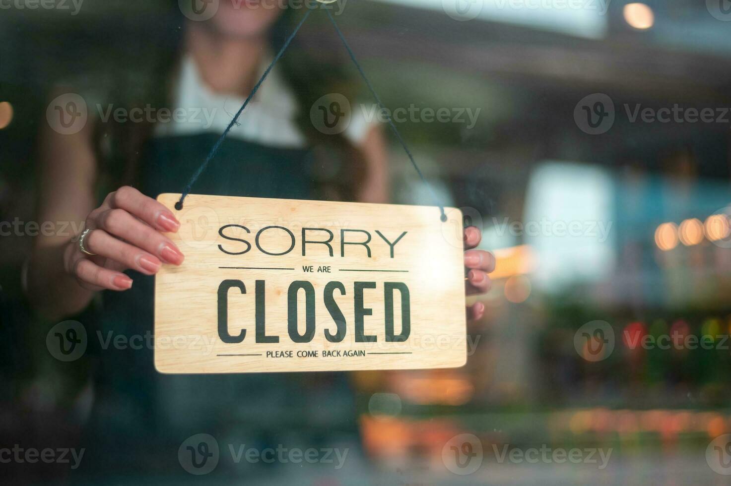 Woman entrepreneur with close sign in cafe shop , small business concept photo
